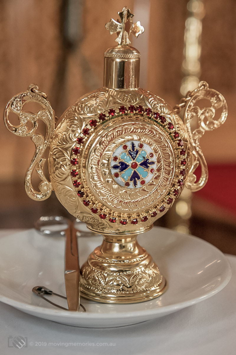 an ornate vessel and the scissors that the priest will use to cut a lock of hair from the baby in a Sydney Greek Orthodox Christening service