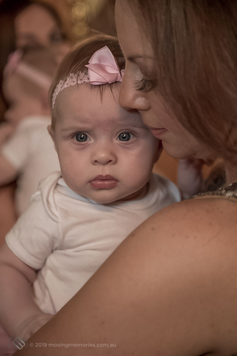 a baby girl held by her God mother before Baptism in a Sydney Greek Orthodox Christening
