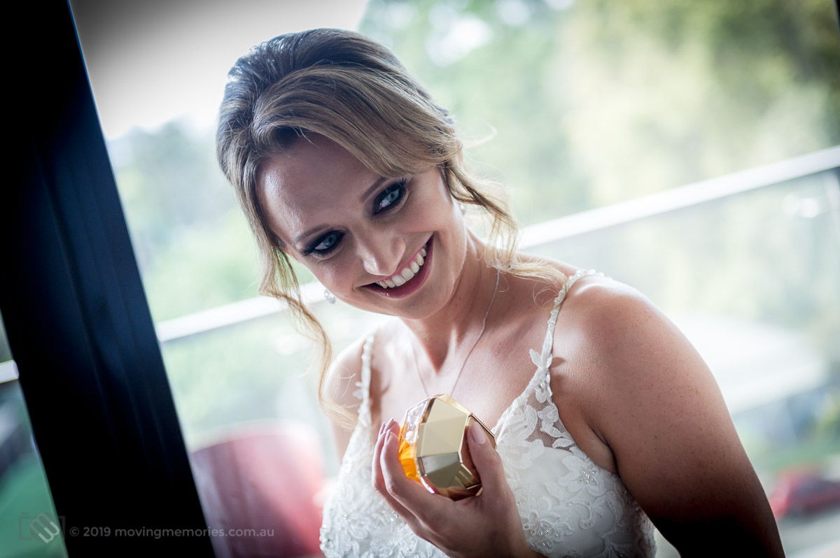 Sydney Bride Rachel poses for a shot with her perfume as she prepared with her bride's maids for her wedding ceremony at the Lakes Sydney