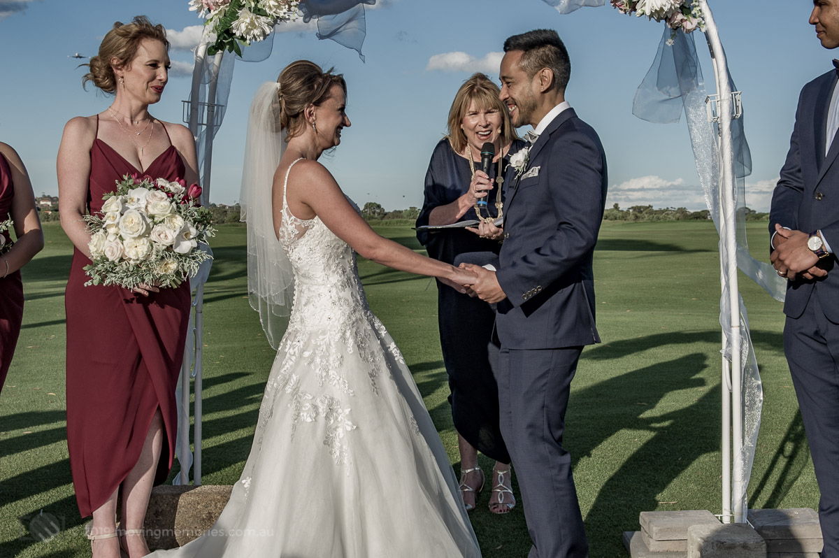 Sydney Groom Ermel, with his Bride Rachel, holding hands at their nuptials on the golf course at the Lakes Sydney