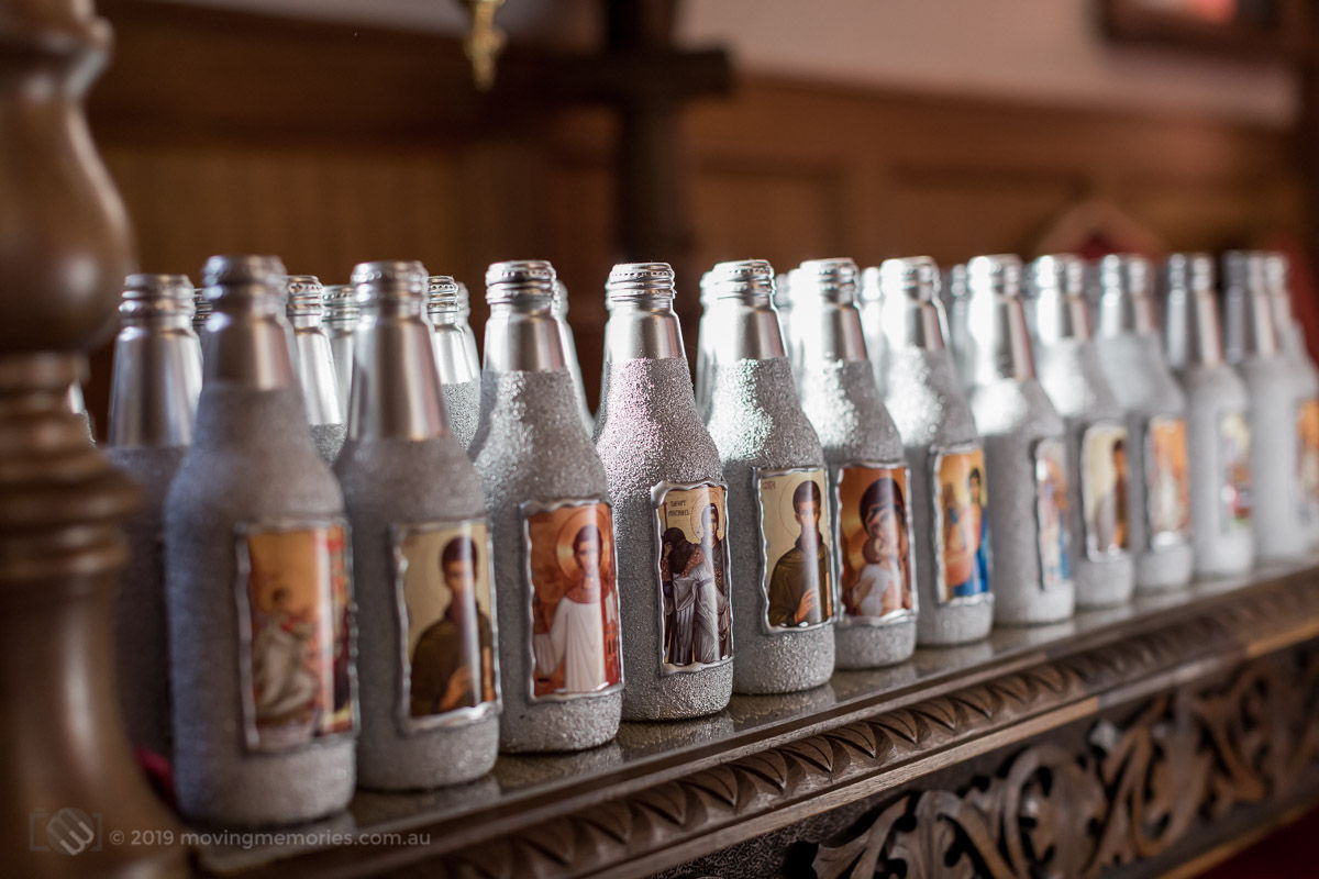 decorative-bottles-of-holy-water-placed-at-the-altar-before-the-ceremony-for-Baby-Girl-Andrjea-Christening-at-Macedonian-Orthodox-Church-Wollongong-Panorama-House