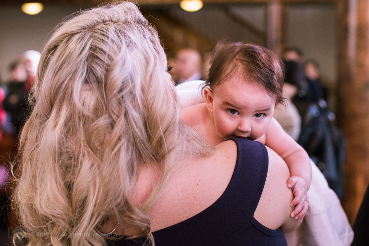 the-baby-girl-held-by-her-God-mother-before-the-ceremony-for-Baby-Girl-Andrea-Christening-at-Macedonian-Orthodox-Church-Wollongong