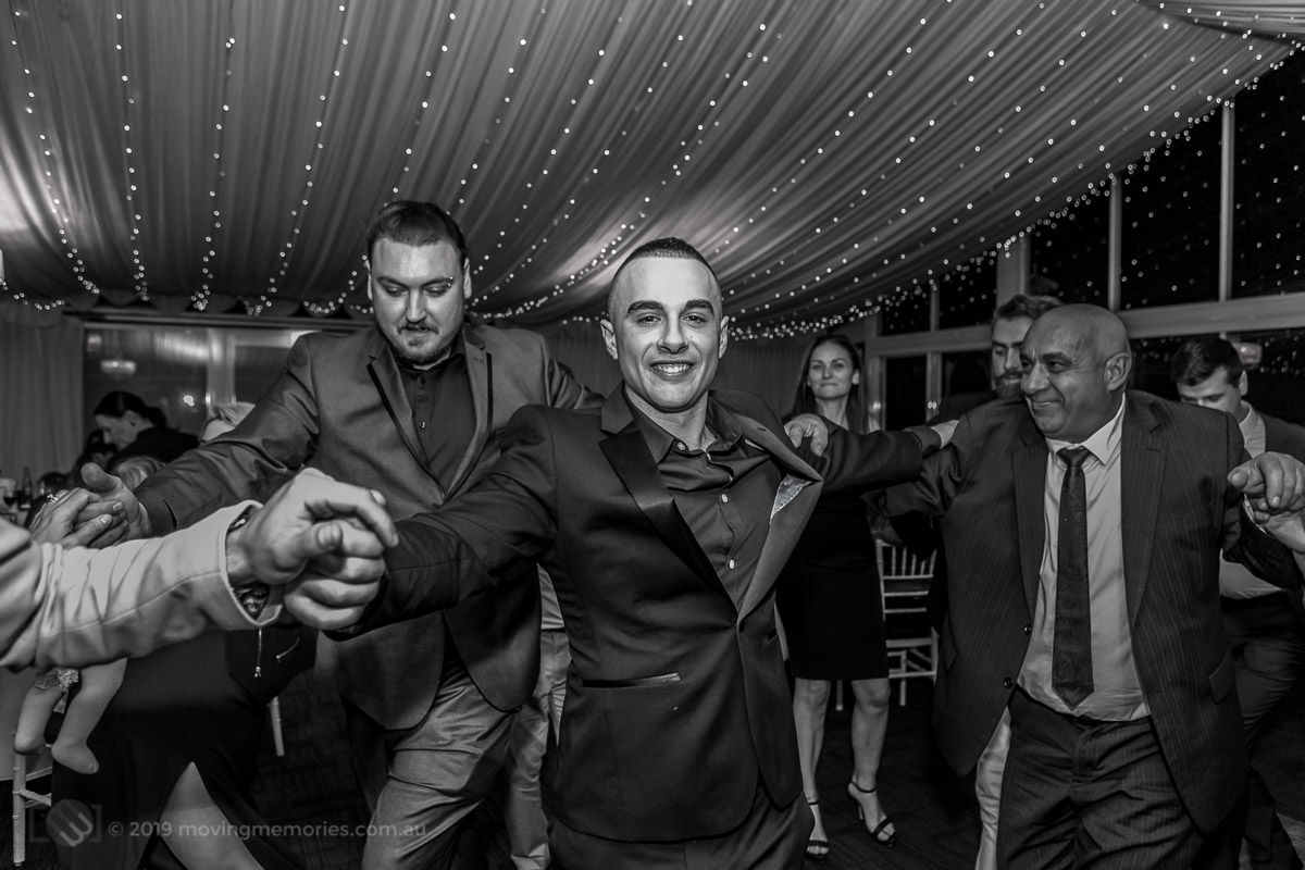 the-God-father-joined-by-the-father-and-other-guests-dancing-at-the-reception-for-Baby-Girl-Andrea-Christening-at-Panorama-House-Bulli-Tops-near-Wollongong